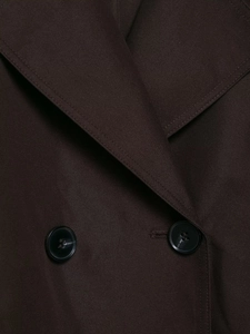 Detail of the chocolate brown double-breasted coat showing twill fabric and black buttons