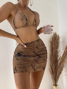 Detail of marble print mesh bikini set with side drawstring skirt and tie-up halter top