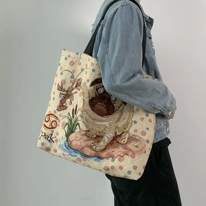 Detail view of large canvas tote bag featuring pug print and jacquard art on shoulder