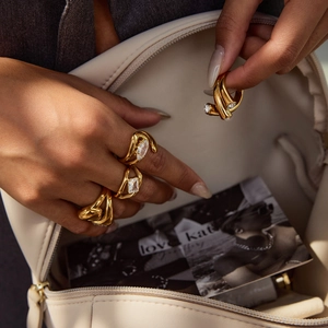 Macro shot of gold plated titanium rings with zircon stones in irregular sleek designs
