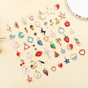 Flat lay of colorful enamel charms in various shapes like hearts and stars for jewelry making