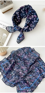Detail of floral cotton linen scarf with blue leaf patterns and silk ribbon texture