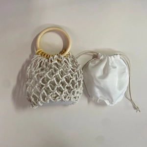 Handmade woven straw shoulder bag with wooden handles and drawstring inner pouch