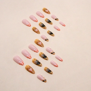 Almond Halloween press-on nails featuring black bats, spider webs, and orange flame designs