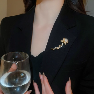 Detail of flower brooch with pearls and zircons on a black suit lapel for an elegant look