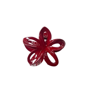Minimalist deep red flower shark hair claw clip made of glossy resin with spring metal grip