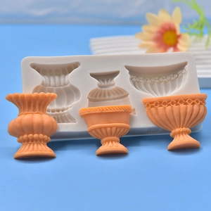 White silicone flower pot mold with three vintage resin vessel styles on blue backdrop