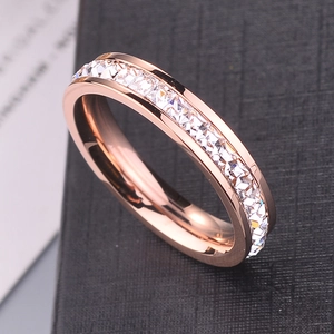 Rose gold titanium steel ring with sparkling square crystals on a black display box