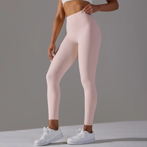 Detail view of high-waist light pink yoga leggings with seamless moisture-wicking fabric
