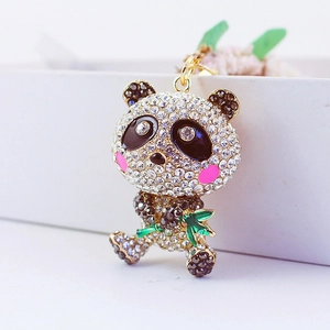 Creative panda keychain with sparkling rhinestones holding green bamboo in gold metal