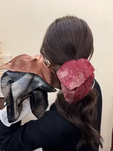 Detailed texture of marble pattern silk hair scrunchies in red and bronze shades