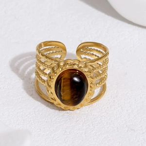 Detail of 18k gold plated stainless steel ring featuring oval tiger eye stone inlay