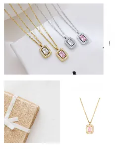 Detail showing square zircon necklaces in gold and silver with emerald-cut emerald-cut gems
