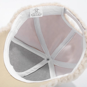 Detail view of cotton inner lining and washing label of thick winter fleece baseball cap