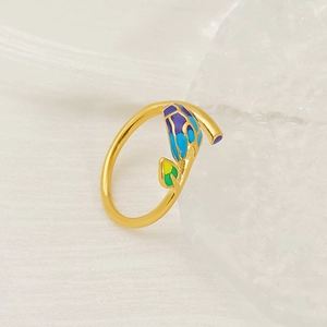 Golden floral leaf open ring with colorful enamel tulip bud design on textured fabric