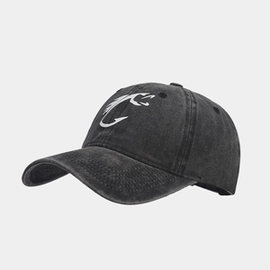 Close-up side view of a black washed distressed baseball cap with white hook logo