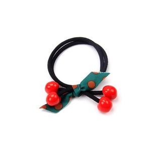 Black double elastic hair tie with red cherry charm and green polka dot ribbon bow