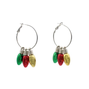 Macro detail of Christmas hoop earrings with red, green, and yellow bulb-shaped pendants