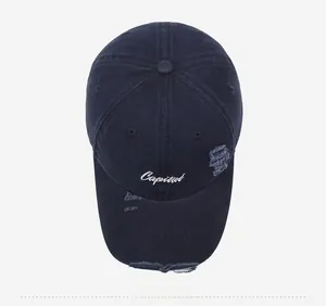Top view of distressed navy baseball cap with Capital embroidery and worn details