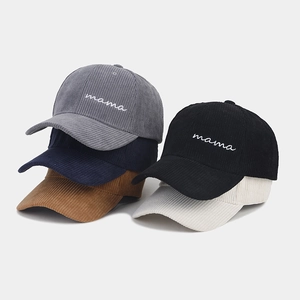 Detailed view of mama embroidered text on five different colored corduroy baseball caps