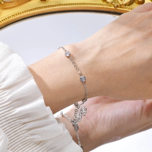 Detail of a minimalist silver stainless steel chain bracelet with sparkling zircons