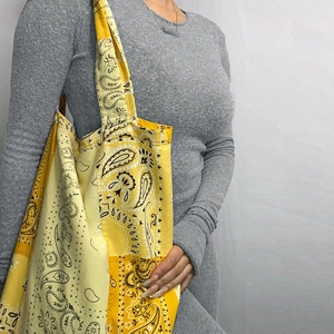 Detail of yellow paisley canvas tote bag featuring large capacity and casual style
