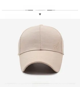 Front view of sand-colored baseball cap showing sport embroidery and long visor detail
