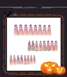 Detail of pink stiletto press on nails with Halloween devil patterns and rhinestones