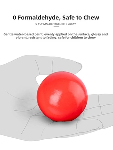 Detail of solid wooden red ball with safe glossy water-based paint for toddlers