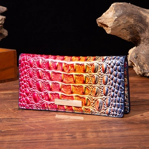 Detail of gradient crocodile pattern leather wallet with vintage gold metal hardware