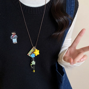 Detail shot of acrylic star pendants and retro card on a brown adjustable cord necklace