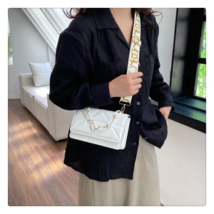 Quilted white crossbody bag with chunky resin chain and wide patterned strap detail