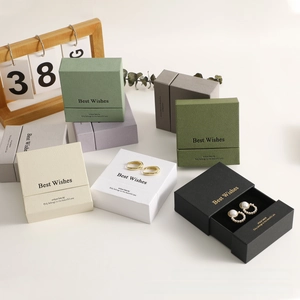 Detail view of colorful jewelry drawer boxes with elegant textures and gold lettering