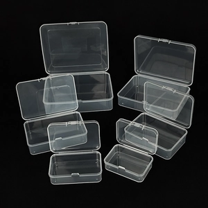 Transparent plastic storage boxes in various sizes with flip lids on black background