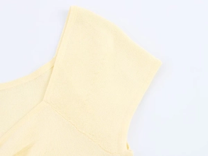 Detailed macro view showing the pleated shoulder seam and fine knit texture of this top
