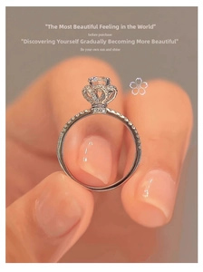 Detailed close-up of a silver crown-shaped diamond ring with intricate pave-set small stones