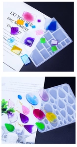Macro detail of silicone jewelry molds with colorful resin drop earrings on a dark background