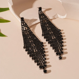 Macro detail of elegant black rhinestone tassel earrings with a triangular silver needle base