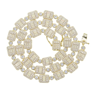 Macro detail of gold hip hop chain featuring rectangular and round zircon gemstones