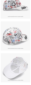Detail of street graffiti print and adjustable metal buckle on white baseball cap