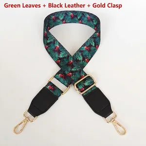 Detail of adjustable floral shoulder strap with tropical green leaves and gold hardware