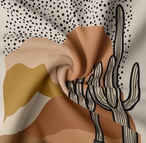 Close-up of bohemian wall tapestry fabric with cacti and abstract geometric patterns