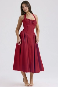 Detail of burgundy halter dress featuring ruffled bodice and structured flared skirt