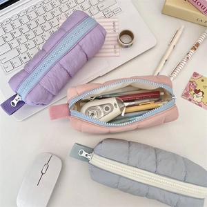 Detailed internal view of padded quilted pencil pouch showing large storage capacity