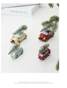 Miniature vintage resin Christmas cars with snow-flocked trees on top for festive decor