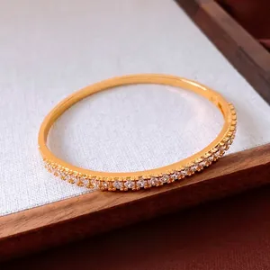 Elegant 24K gold plated minimalist bangle with pavé set sparkling circular crystals