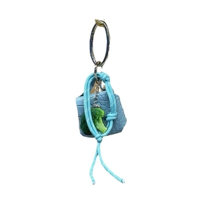 Blue mini bag keychain with broccoli charm and braided cord on a metal ring