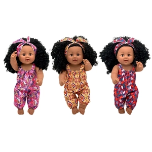 Three realistic African baby dolls in vibrant floral rompers and matching headbands