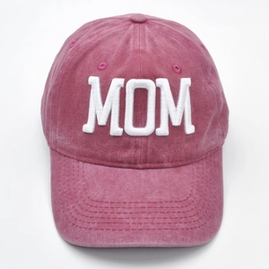 Detailed view of 3D embroidered MOM text on washed red cotton canvas baseball cap