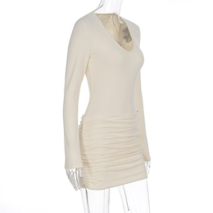 Detailed side view of cream ruched deep V-neck dress showing slimming pleated texture